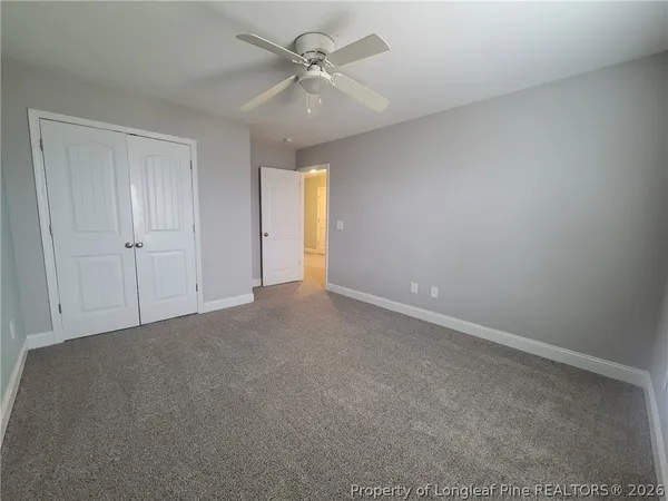 a view of an empty room and a ceiling fan