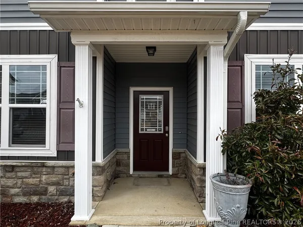 a view of a house with potted plants