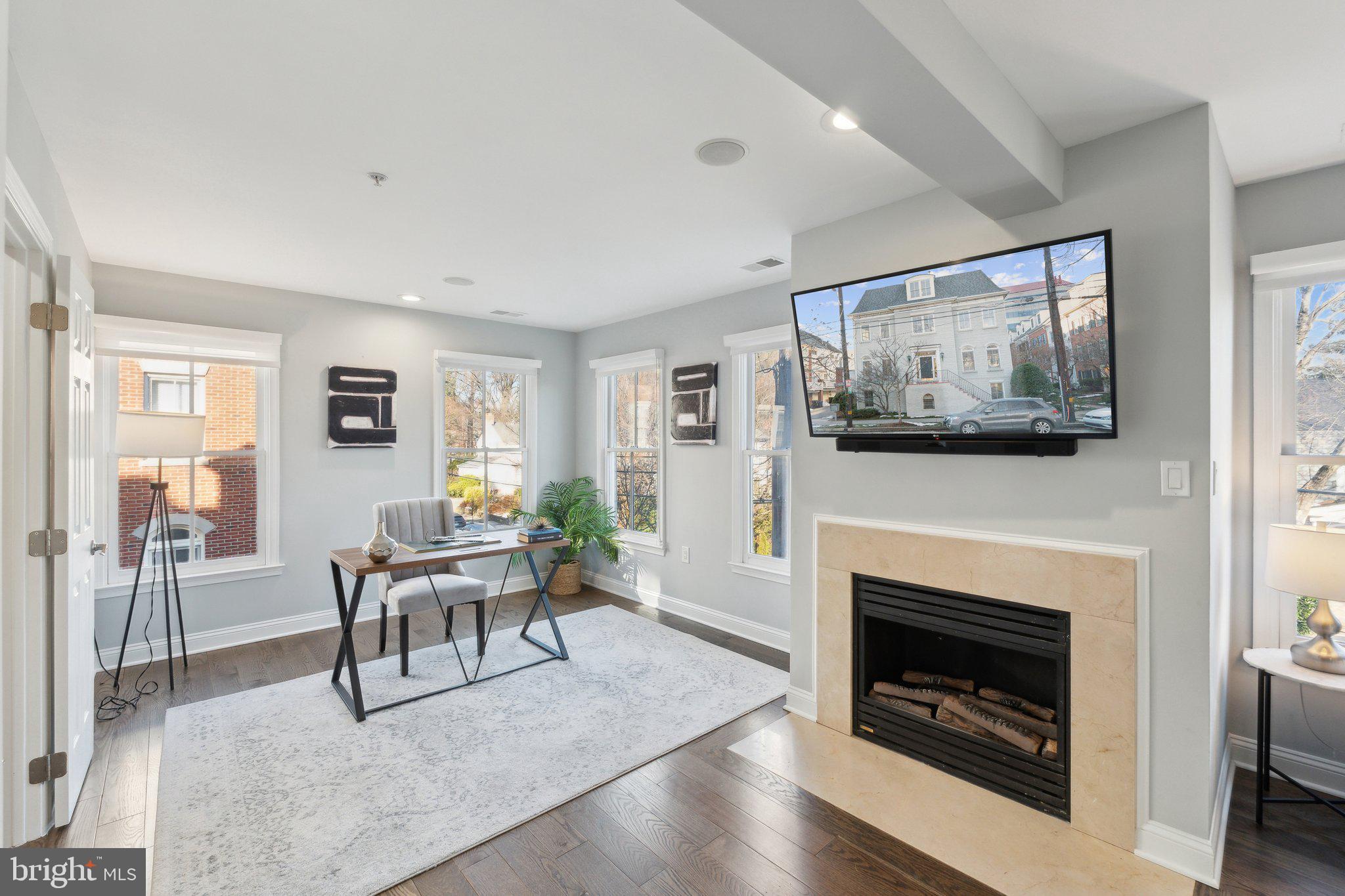 5334 43rd Street Northwest Washington, DC 20015 - Photo 11 of 32 a living room with furniture a flat screen tv and a fireplace