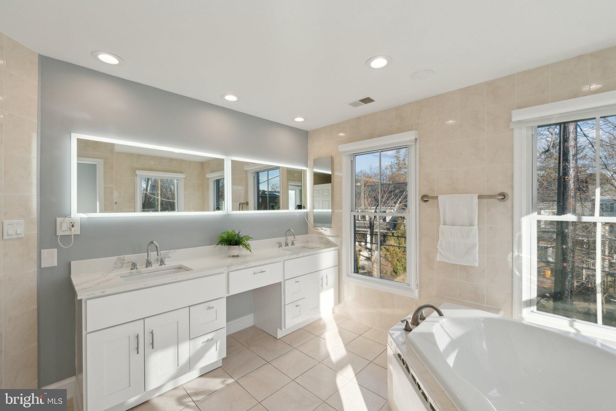 5334 43rd Street Northwest Washington, DC 20015 - Photo 14 of 32 a spacious bathroom with a double vanity sink a mirror and a bathtub