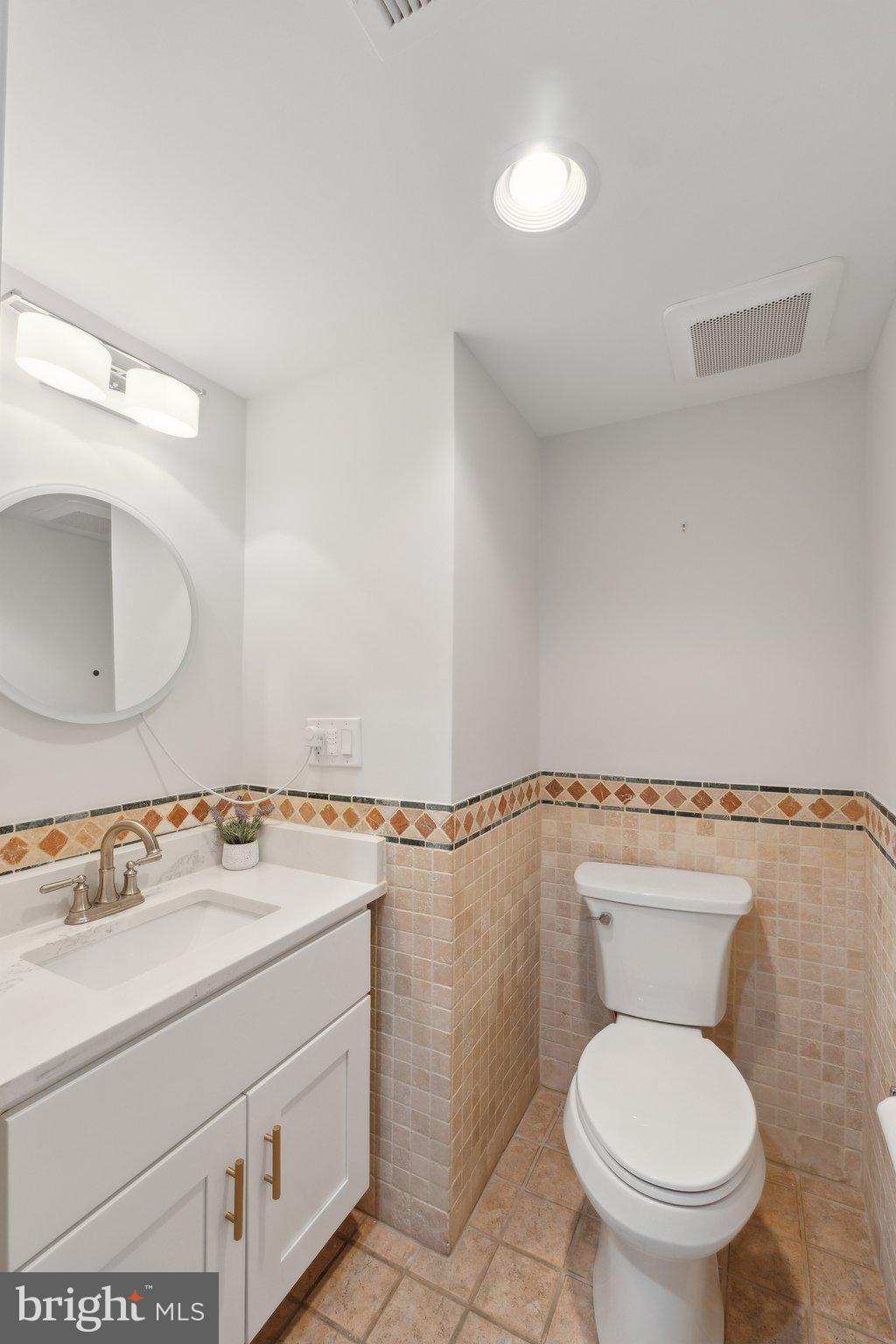 5334 43rd Street Northwest Washington, DC 20015 - Photo 29 of 32 a bathroom with a sink mirror vanity and toilet