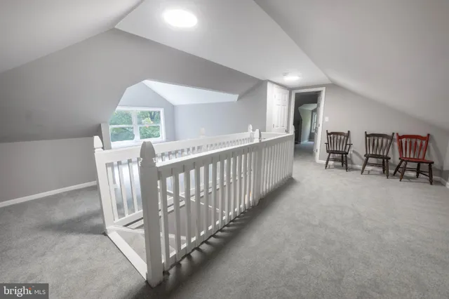 a view of a hallway with furniture and a chandelier