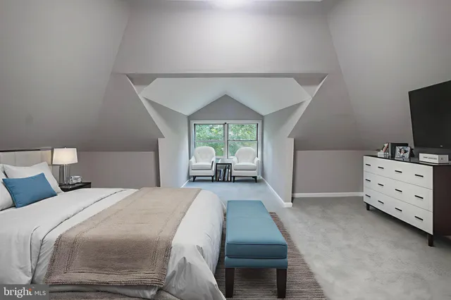 a spacious bedroom with a bed and a large window