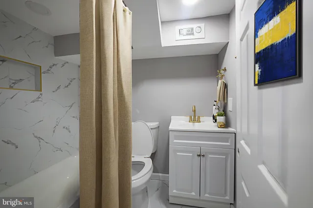 a bathroom with a sink a toilet and vanity