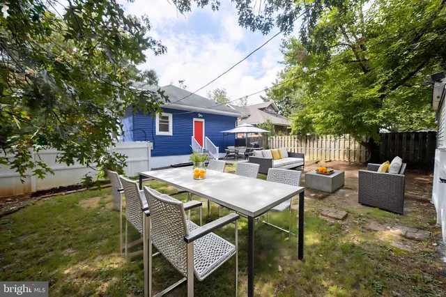 a backyard of a house with table and chairs