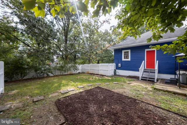 a backyard of a house with yard and outdoor seating