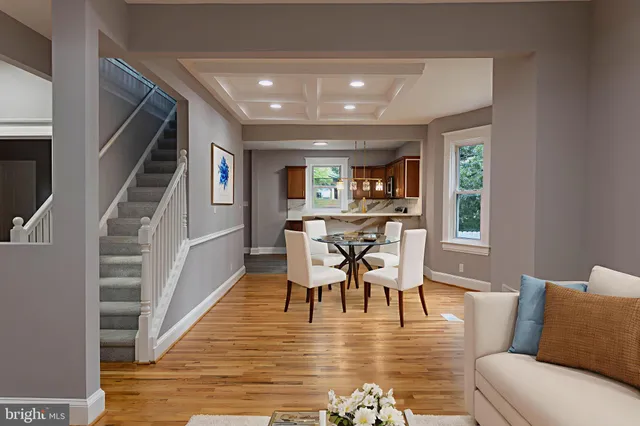 a view of a dining room with furniture a rug and wooden floor
