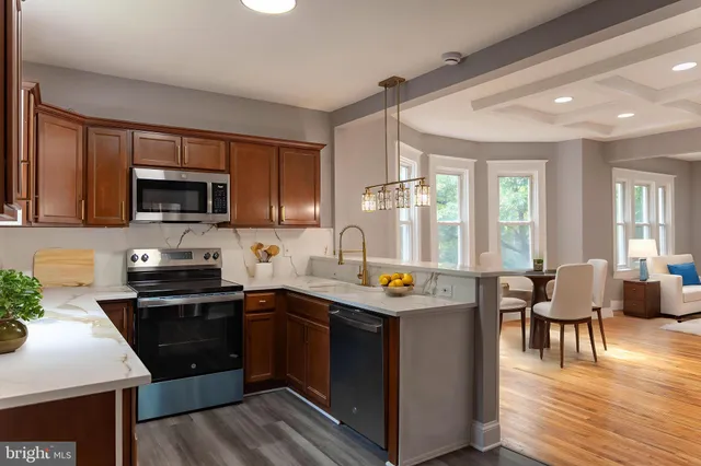 a kitchen with stainless steel appliances granite countertop a sink stove and microwave