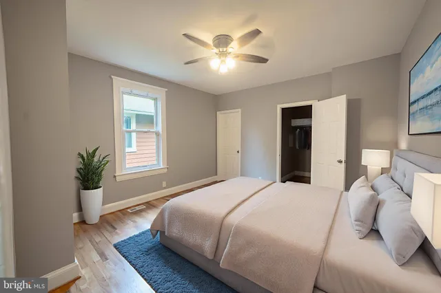 a spacious bedroom with a large bed and a chandelier