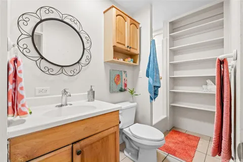 a bathroom with a toilet a sink and a mirror