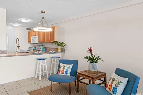 a view of a workspace with furniture and a potted plant
