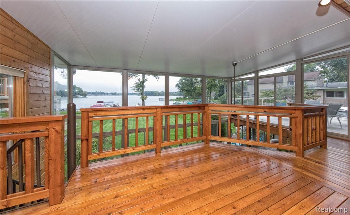 7272 Hatchery Road Waterford, MI 48327 - Photo 15 of 46 Private balcony connects to Dura Deck and stairs that lead down to 3 season atrium.