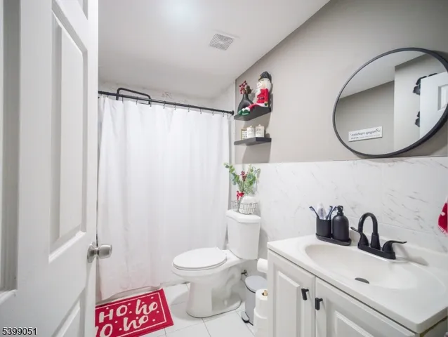 a kitchen with a table chairs microwave and cabinets