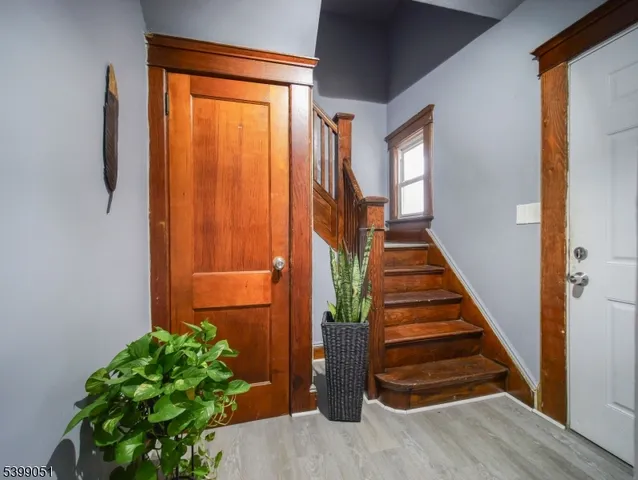 a kitchen view with stainless steel appliances wooden floor dining table and chairs