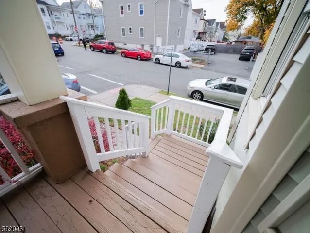 a view of a porch with wooden floor and outdoor seating