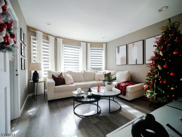 a living room with a flat screen tv and a potted plant