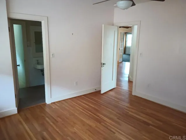 an empty room with wooden floor and closet