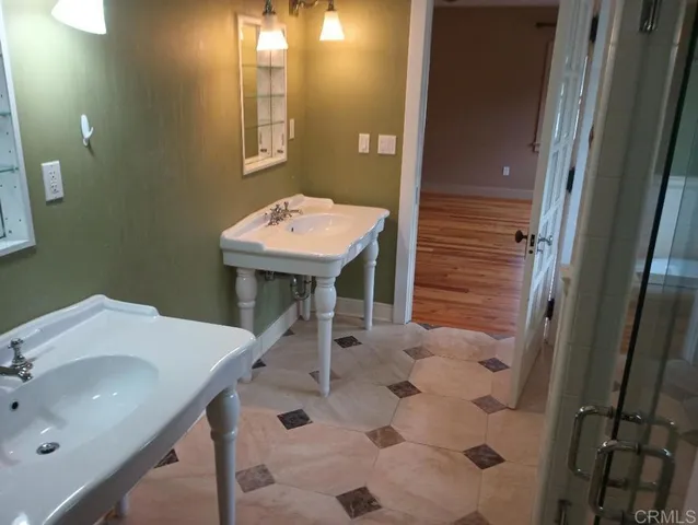 a bathroom with a sink a toilet and mirror