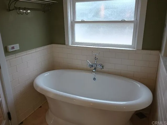 a white bath tub sitting in a bathroom