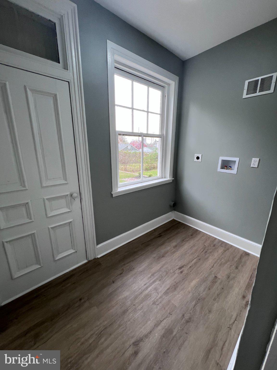 26 East 5th Street Pottstown, PA 19464 - Photo 11 of 37 an empty room with wooden floor and windows