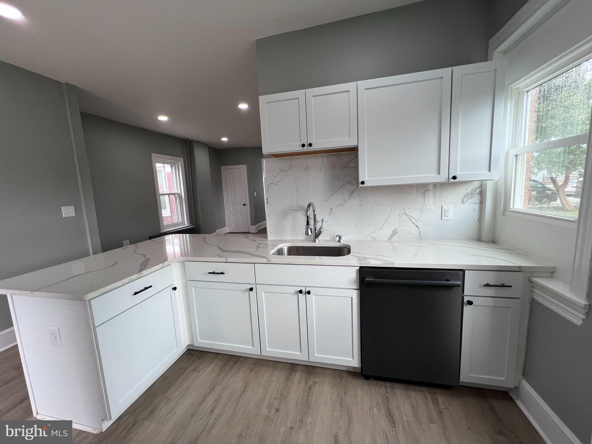 26 East 5th Street Pottstown, PA 19464 - Photo 16 of 37 a kitchen with granite countertop white cabinets and white appliances