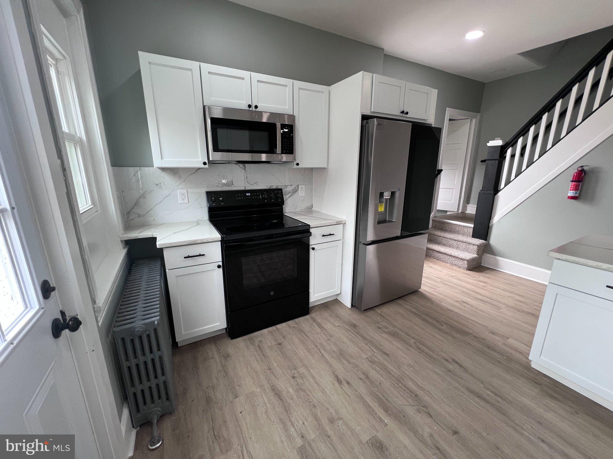 26 East 5th Street Pottstown, PA 19464 - Photo 17 of 37 a kitchen with a refrigerator stove and wooden floor