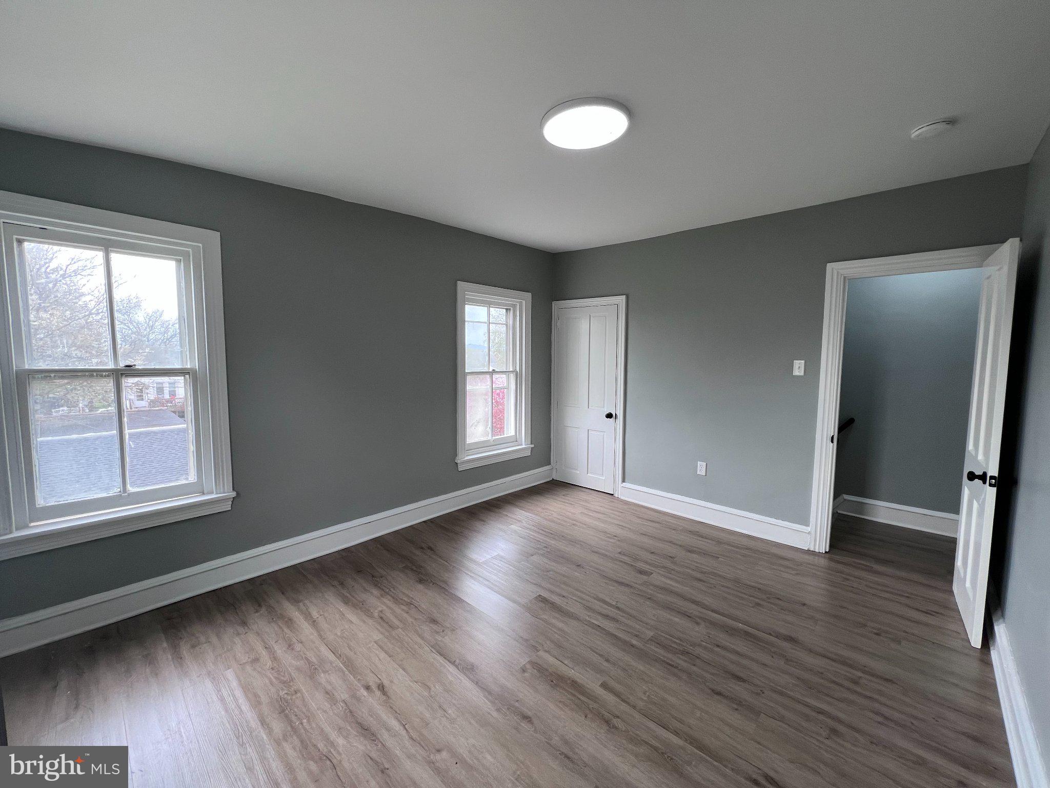 26 East 5th Street Pottstown, PA 19464 - Photo 20 of 37 an empty room with wooden floor and windows