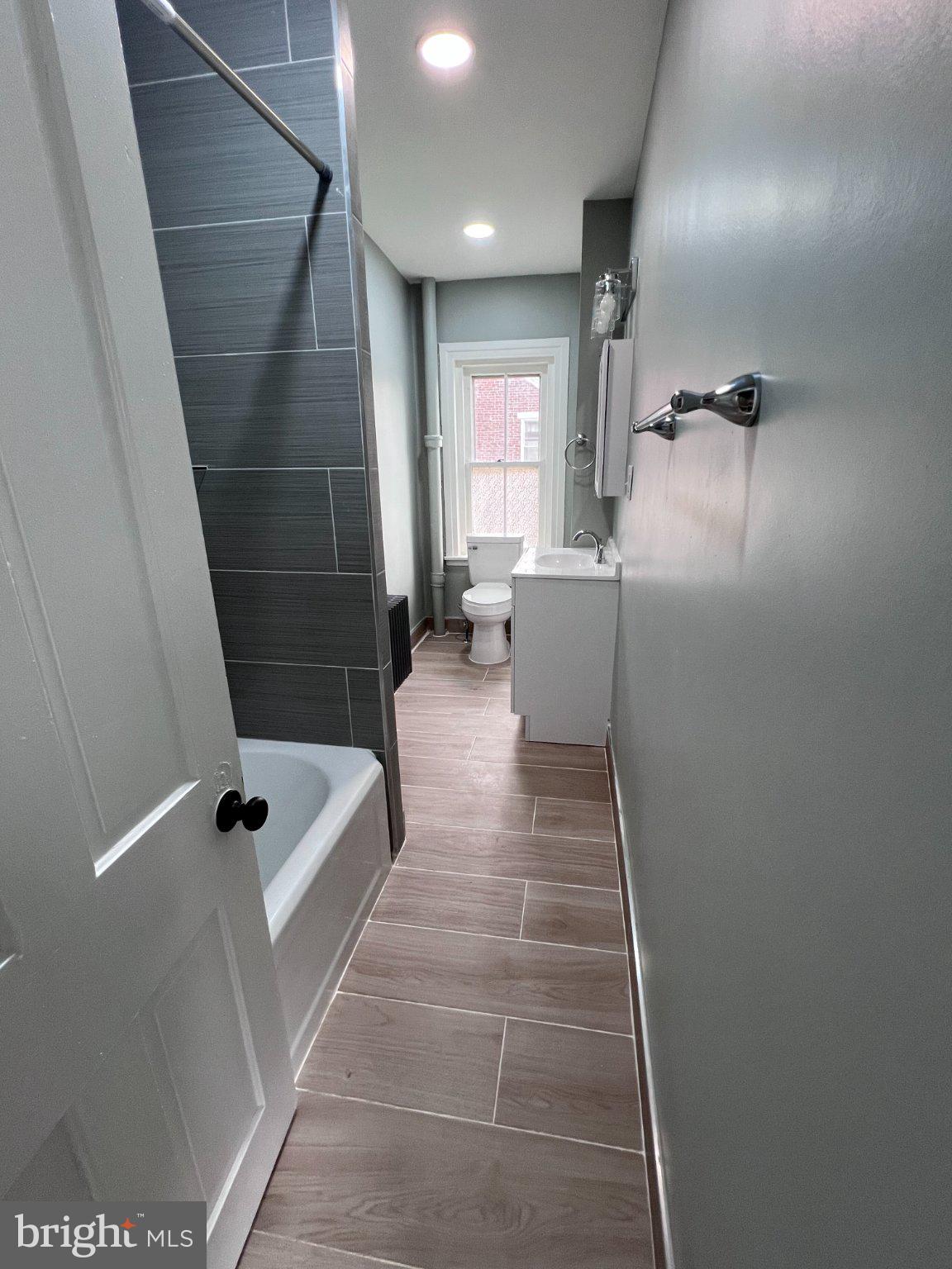 26 East 5th Street Pottstown, PA 19464 - Photo 21 of 37 a bathroom with a tub a window and a shower