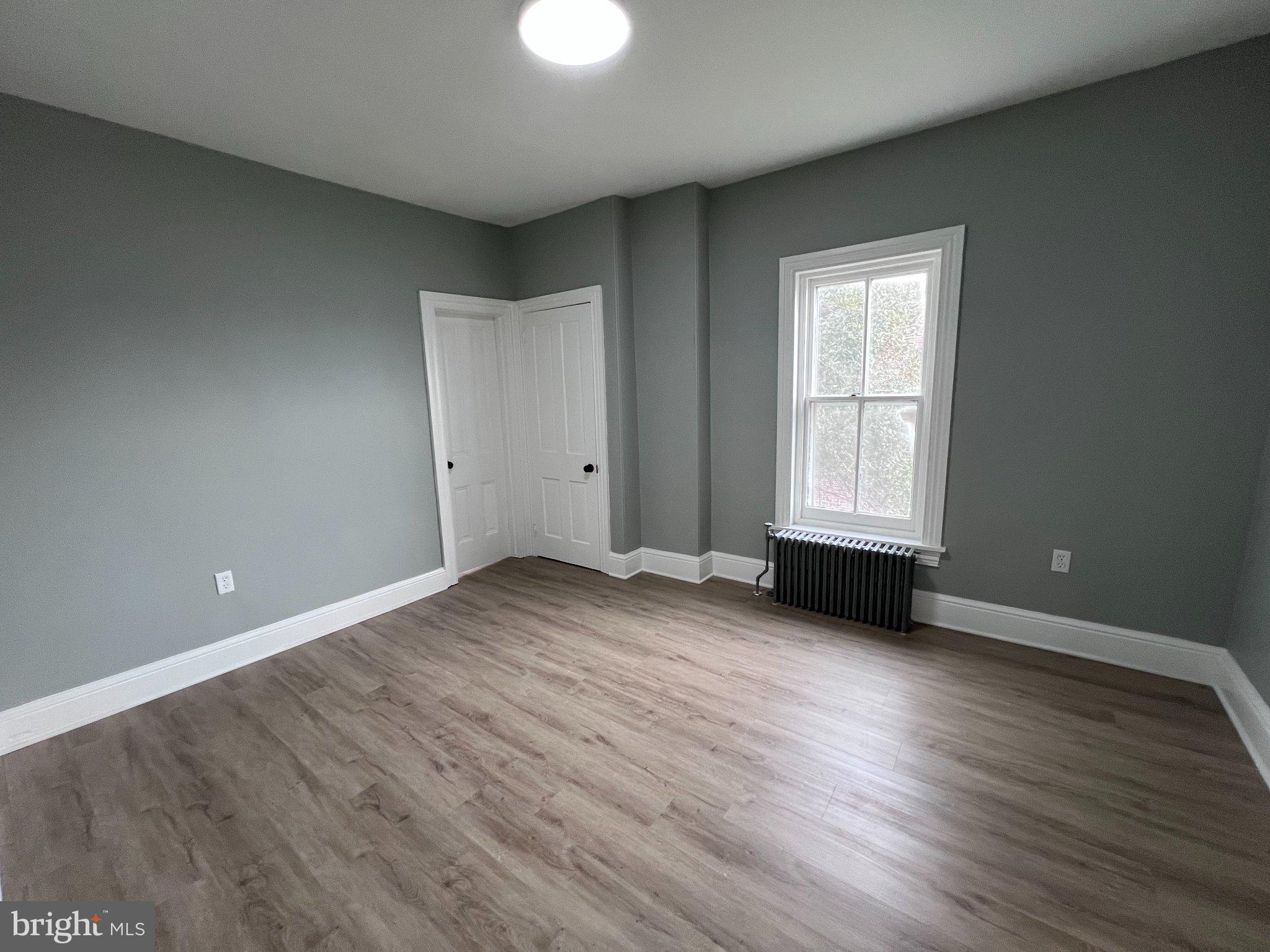 26 East 5th Street Pottstown, PA 19464 - Photo 24 of 37 an empty room with wooden floor and windows