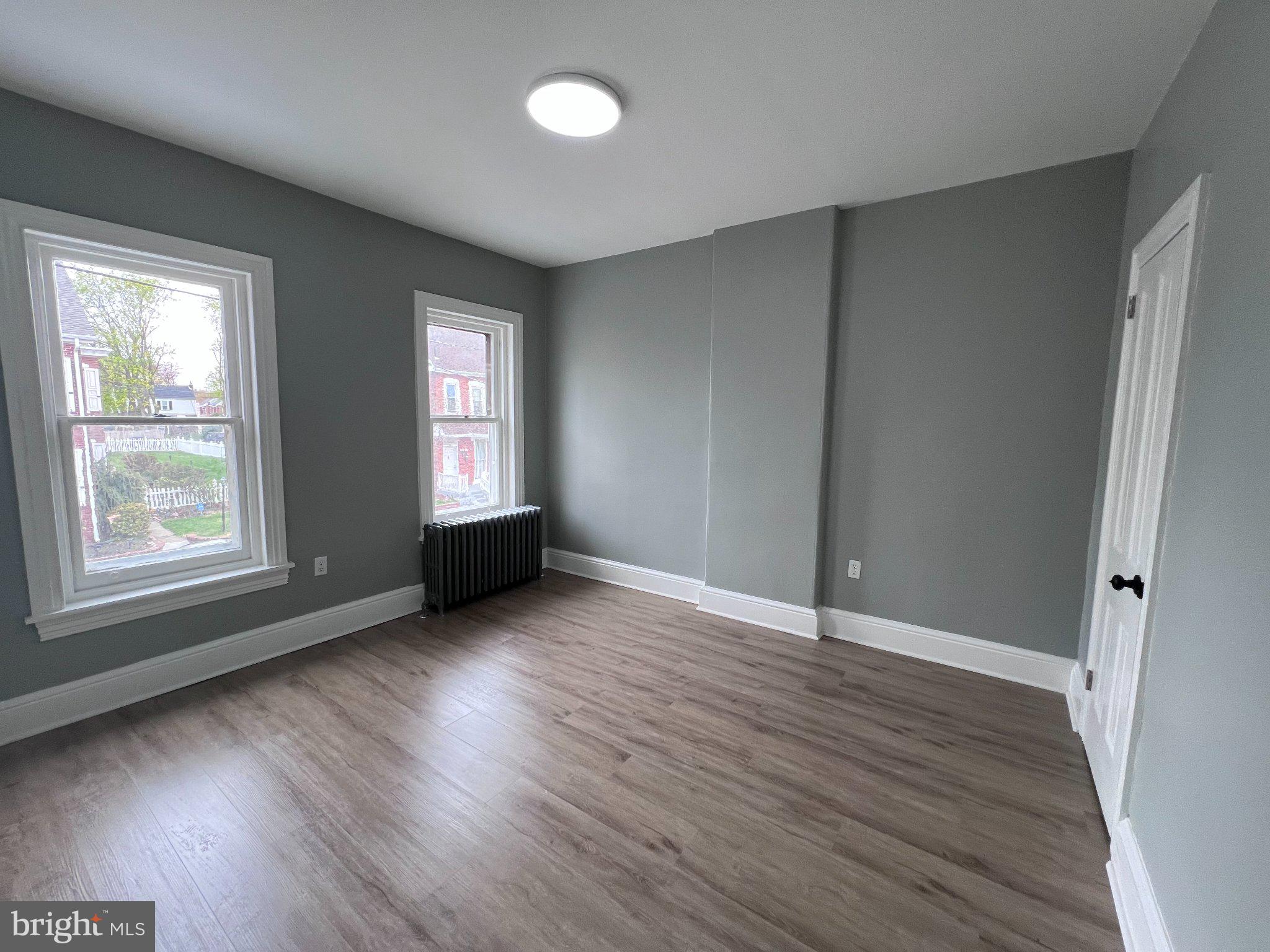 26 East 5th Street Pottstown, PA 19464 - Photo 26 of 37 an empty room with wooden floor and windows