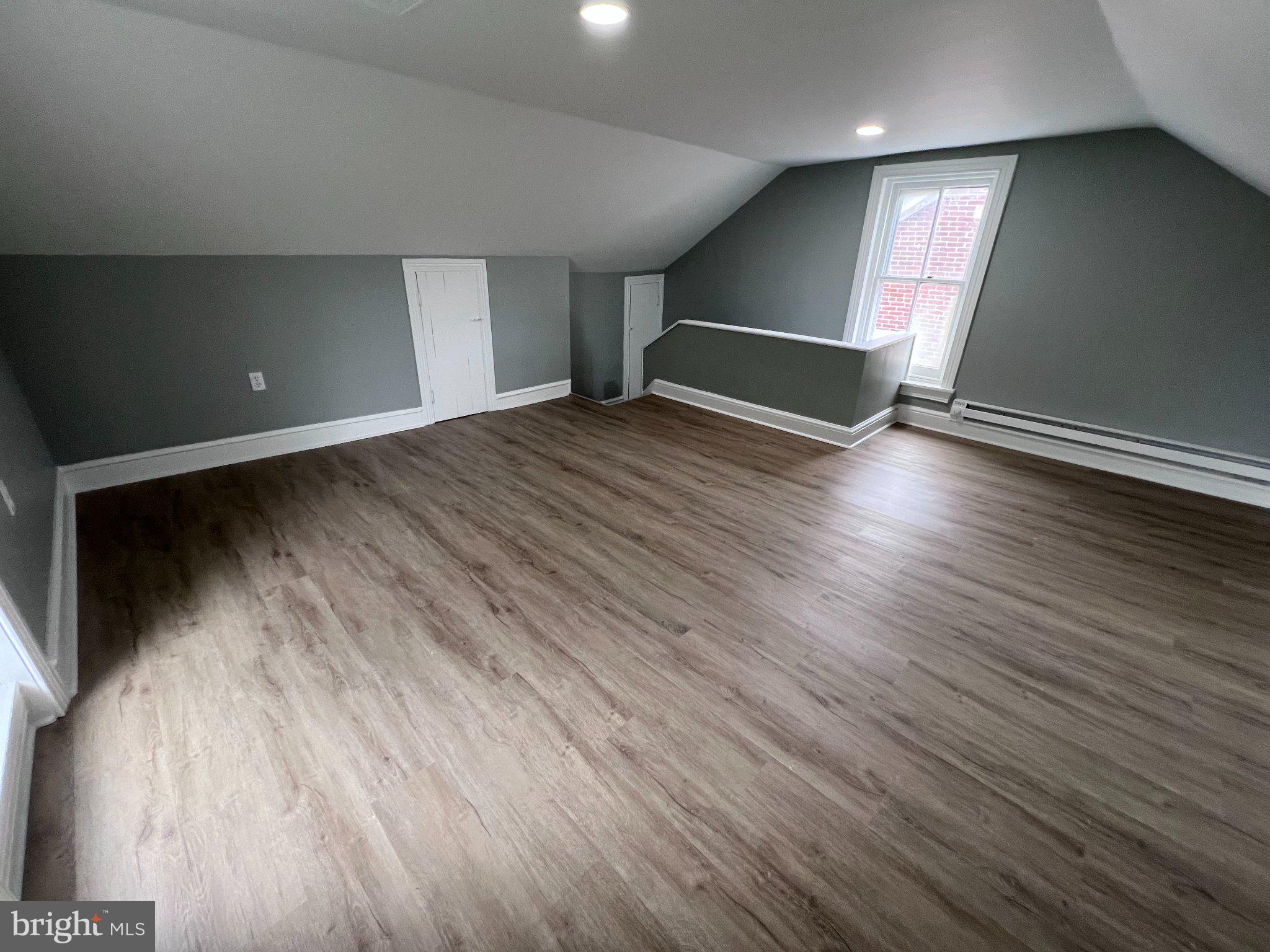 26 East 5th Street Pottstown, PA 19464 - Photo 30 of 37 an empty room with wooden floor and windows