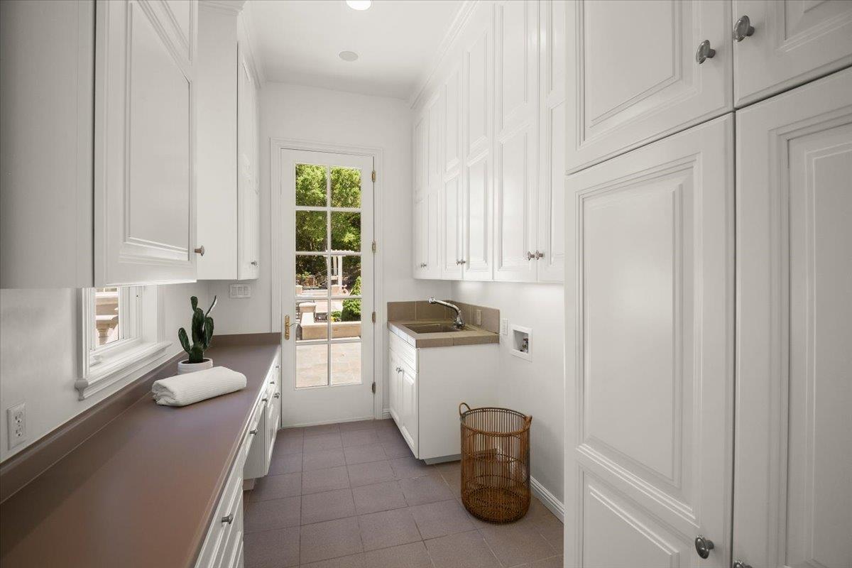 14113 Pike Road Saratoga, CA 95070 - Photo 31 of 78 a kitchen with a refrigerator and white cabinets