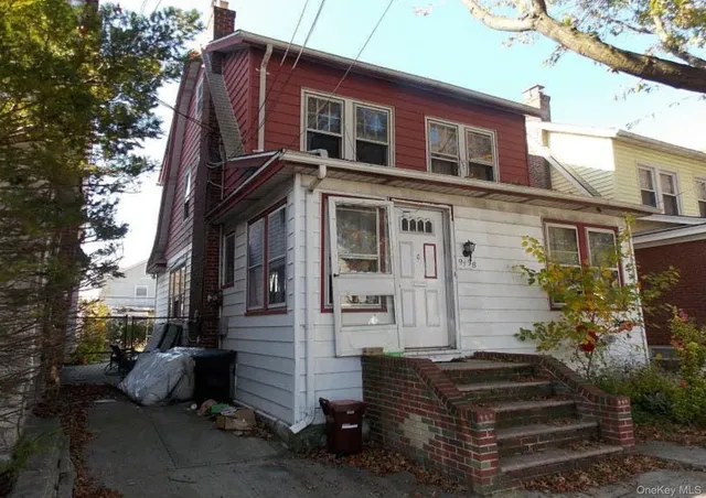 a front view of a house with a garden