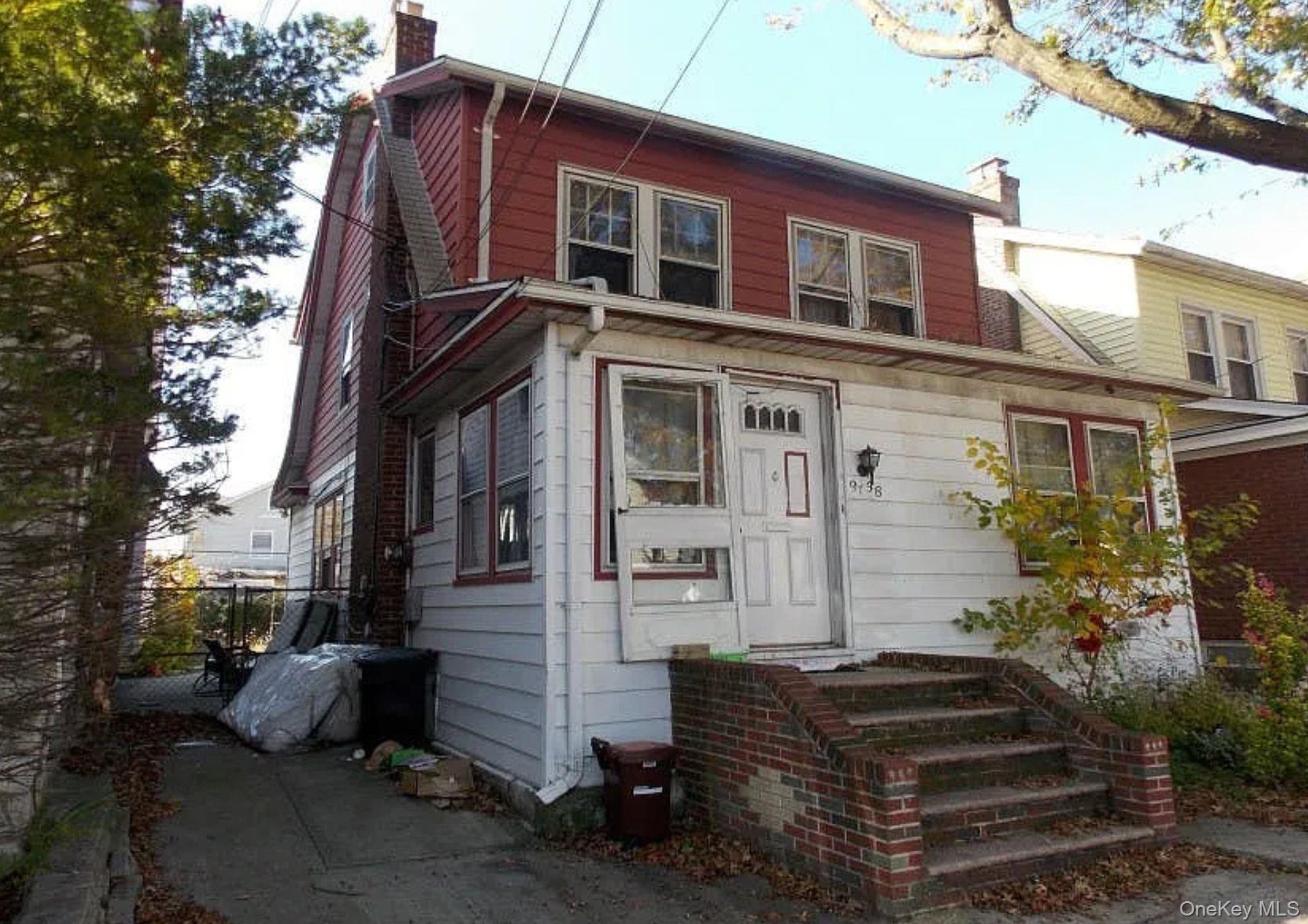 91-38 Springfield Boulevard Queens, NY 11428 - Photo 1 of 4 a front view of a house with a garden