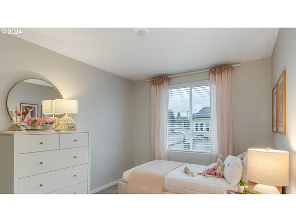 a bedroom with a bed and window