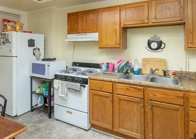 a kitchen with sink cabinets and appliances