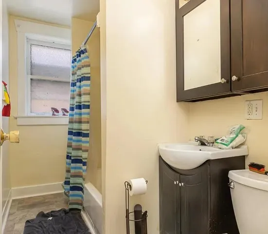 a bathroom with a sink a toilet and a mirror