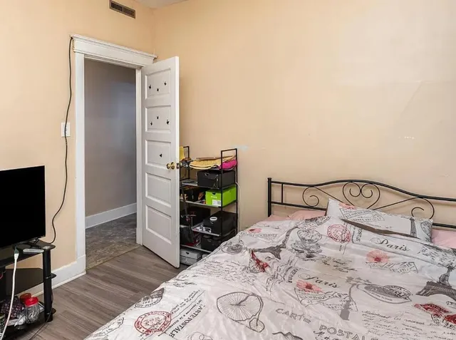 a bedroom with a bed and a flat screen tv