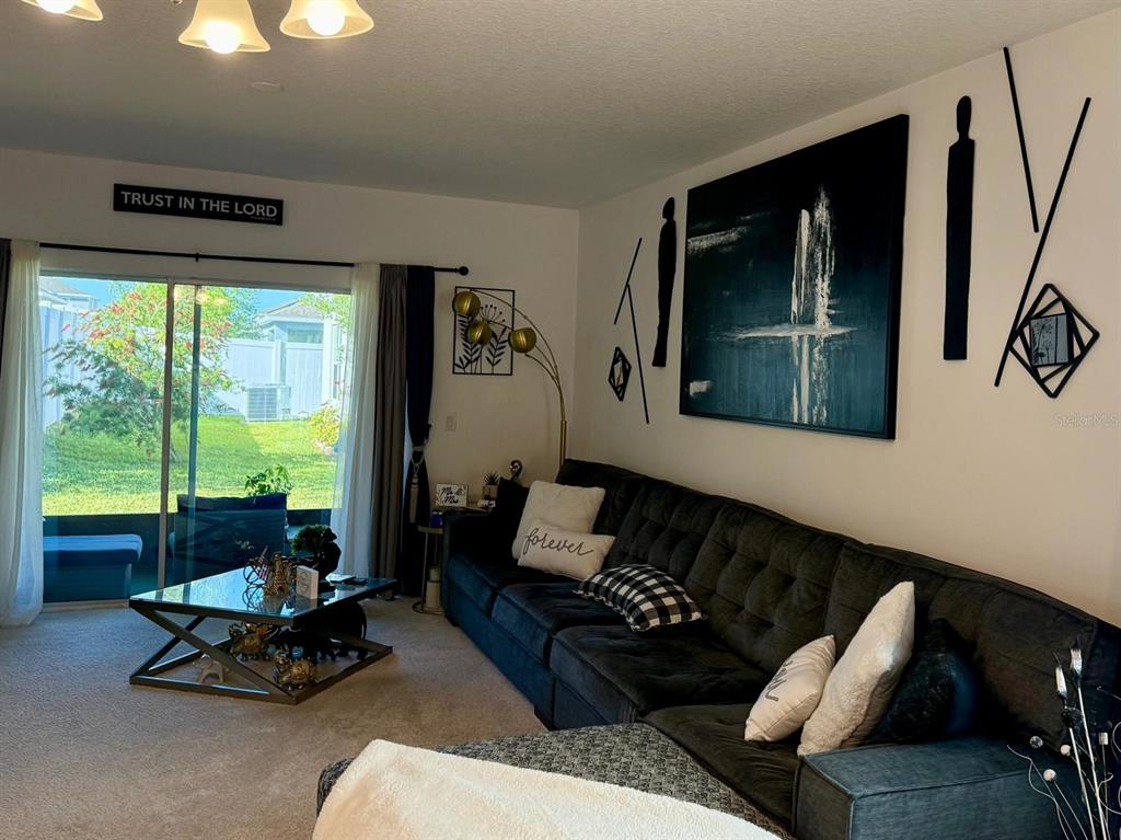 813 Marcel Loop Davenport, FL 33837 - Photo 11 of 34 a living room with furniture and a large window