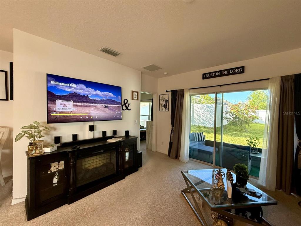 813 Marcel Loop Davenport, FL 33837 - Photo 14 of 34 a living room with furniture and a flat screen tv