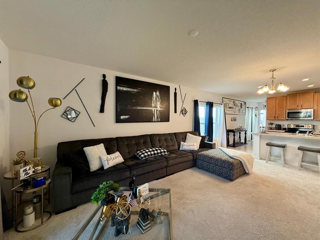 813 Marcel Loop Davenport, FL 33837 - Photo 15 of 34 a living room with furniture and wooden floor