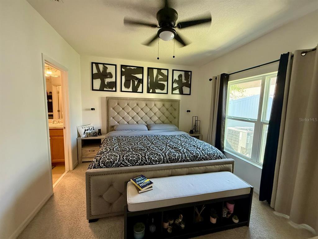 813 Marcel Loop Davenport, FL 33837 - Photo 17 of 34 a bedroom with a bed and a window