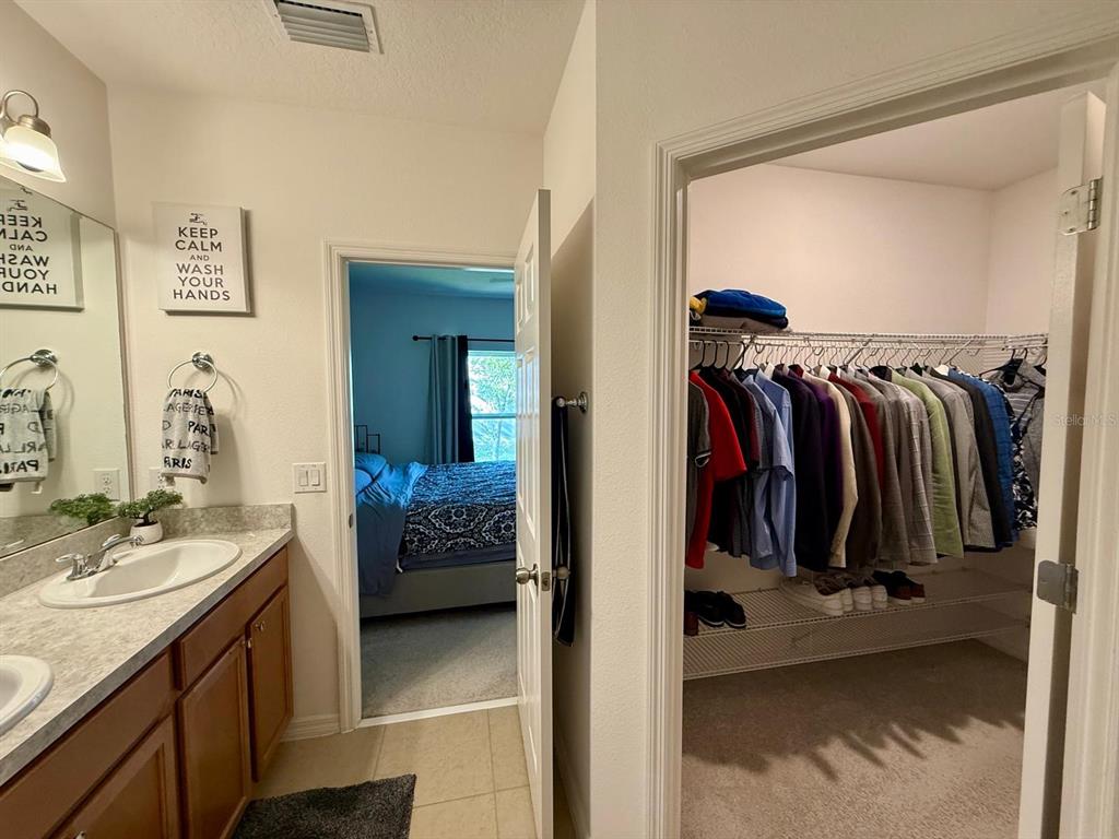 813 Marcel Loop Davenport, FL 33837 - Photo 21 of 34 a view of walk in closet with clothes and shoes