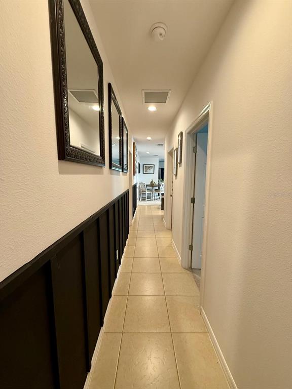 813 Marcel Loop Davenport, FL 33837 - Photo 22 of 34 a view of a hallway with wooden floor and staircase