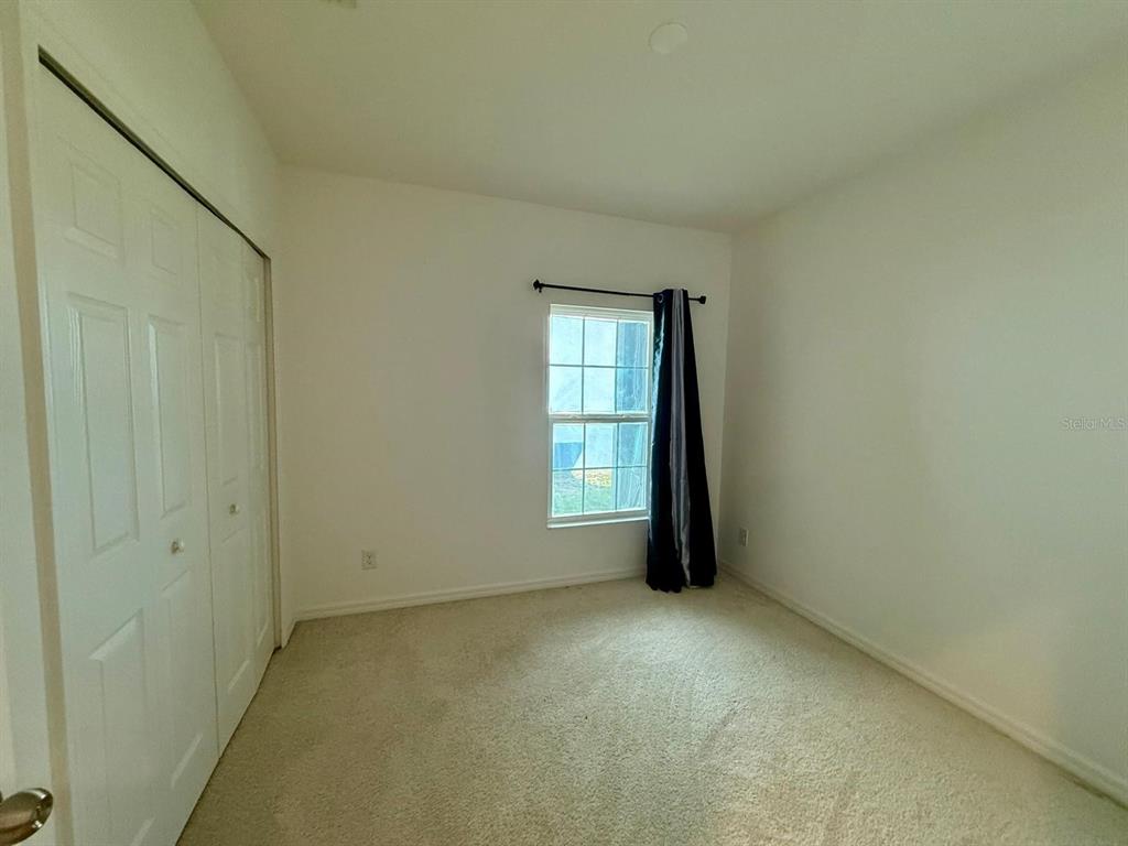 813 Marcel Loop Davenport, FL 33837 - Photo 23 of 34 an empty room with a window