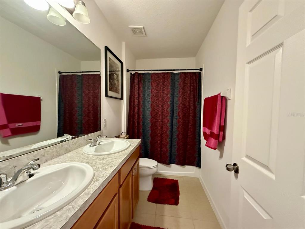 813 Marcel Loop Davenport, FL 33837 - Photo 26 of 34 a bathroom with a sink and a mirror