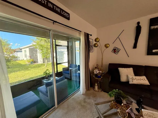 a dining room with furniture and a potted plant
