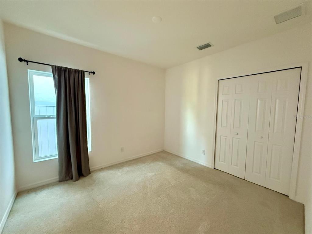 813 Marcel Loop Davenport, FL 33837 - Photo 31 of 34 an empty room with closet area