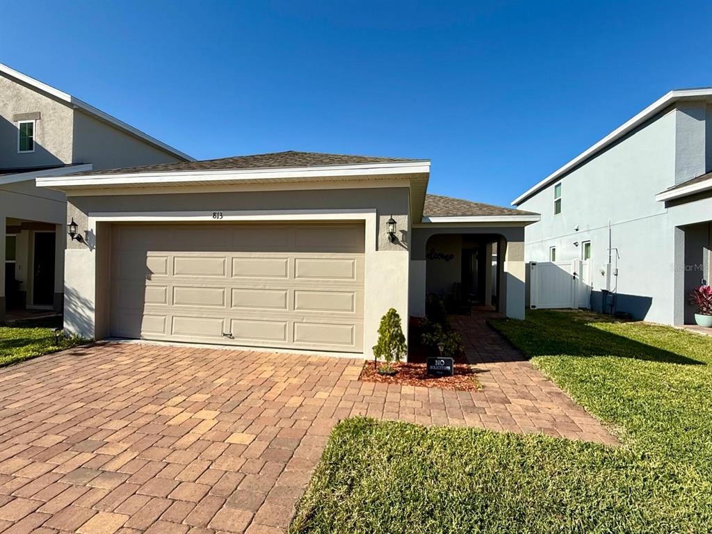 813 Marcel Loop Davenport, FL 33837 - Photo 32 of 34 a front view of a house with a yard