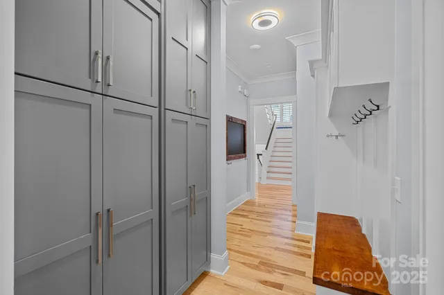 a view of entryway and hall with wooden floor